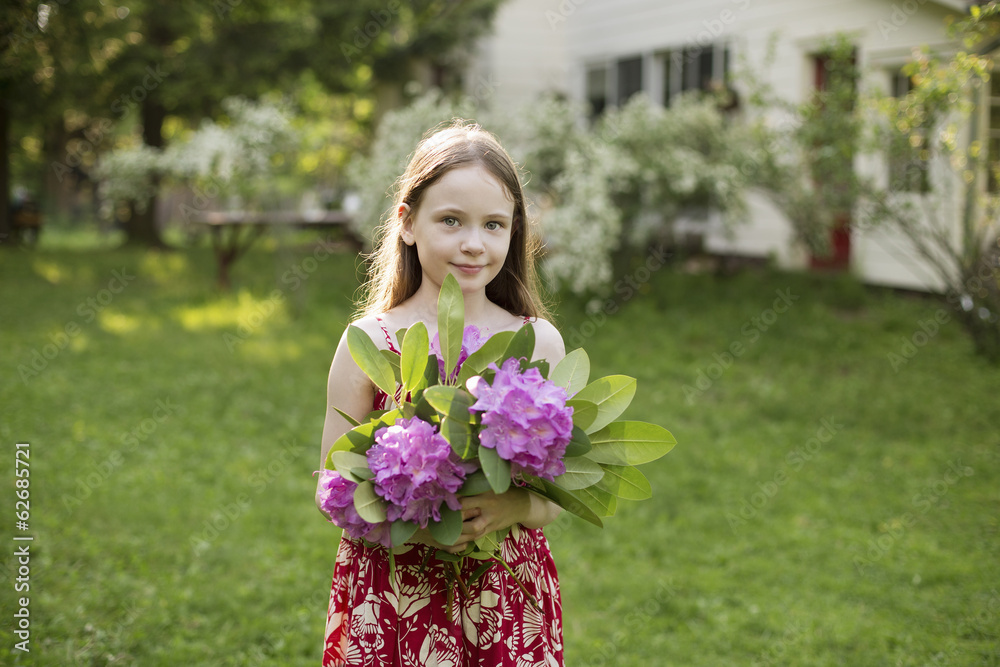 A Young Girl Holding A Bunch Of Purple Hydrangea Flowerheads. A Young Girl Holding A Bunch Of Purple Hydrangea Flowerheads.