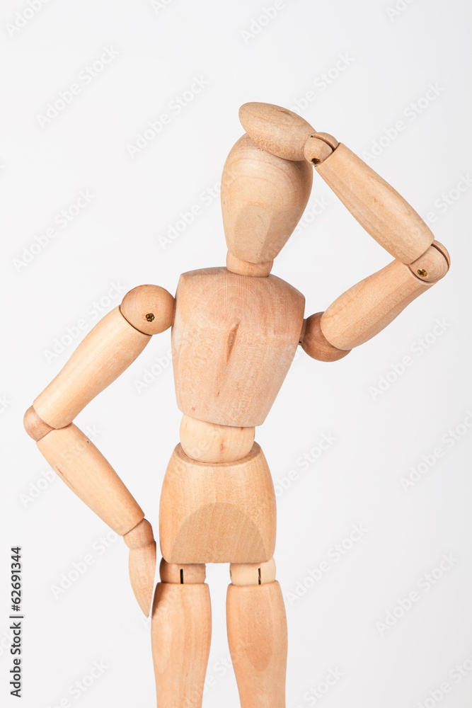 Plain wood mannequin stand upright isolated on white holding hea Plain wood mannequin stand upright isolated on white holding hea