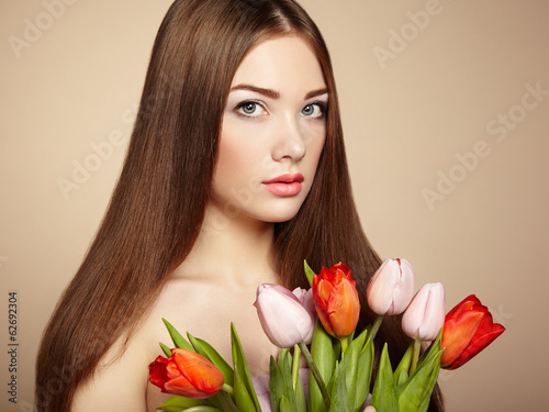 Portrait of beautiful dark-haired woman with flowers