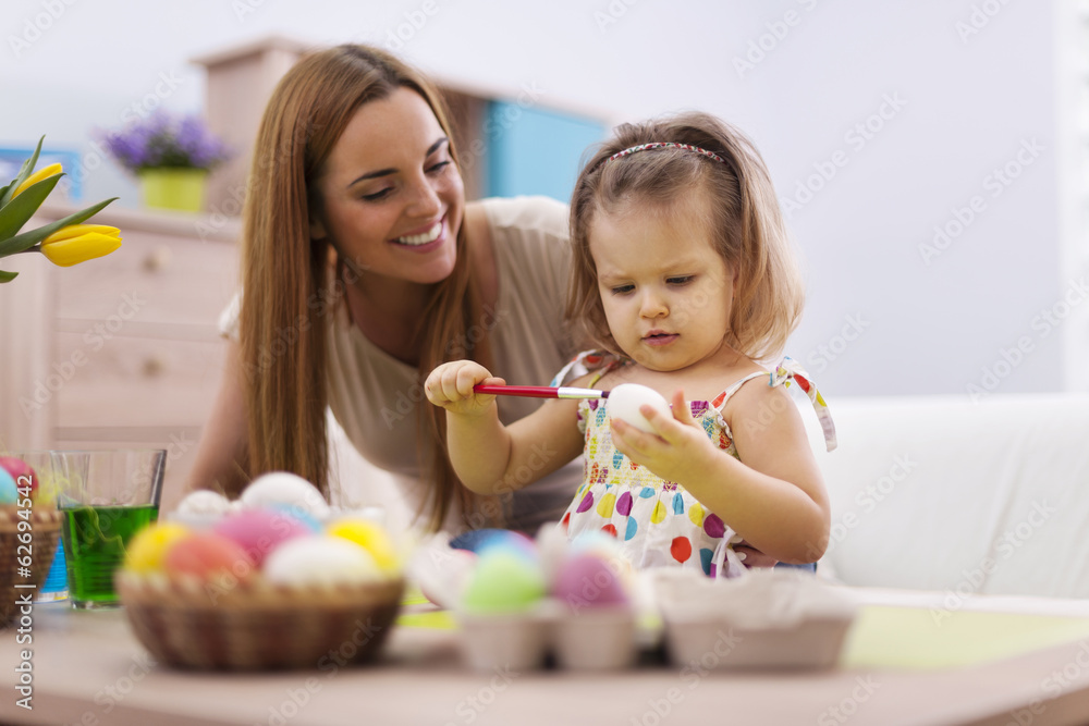 Fototapeta premium Family playing during painting easter eggs