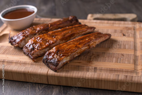 RIbs on a cutting board with BBQ sauce