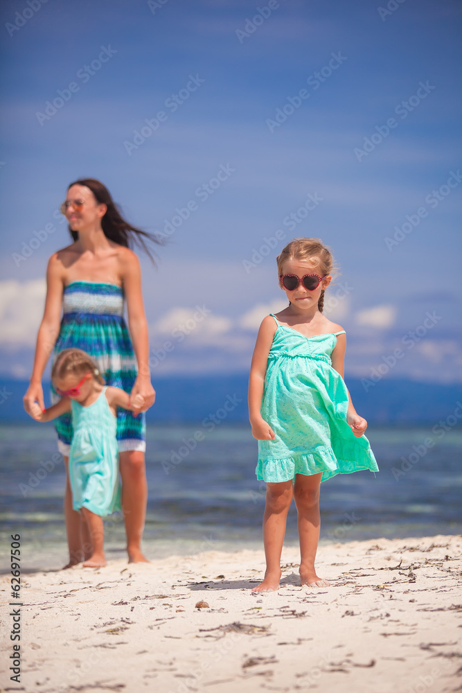 Young happy mother and her adorable daughters having fun at