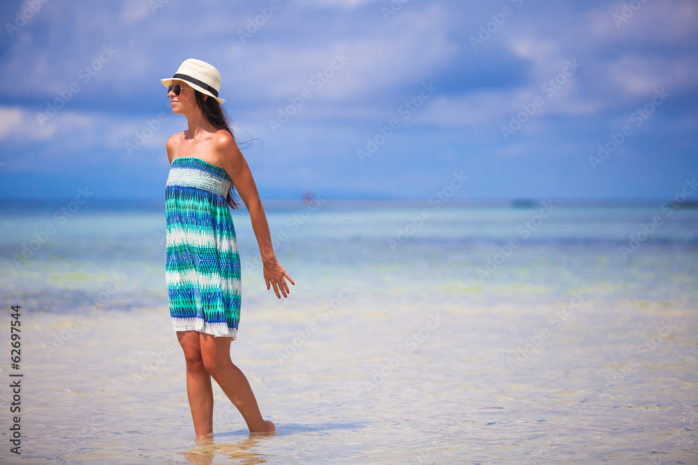 Young woman enjoying the holiday on a white, tropical beach at