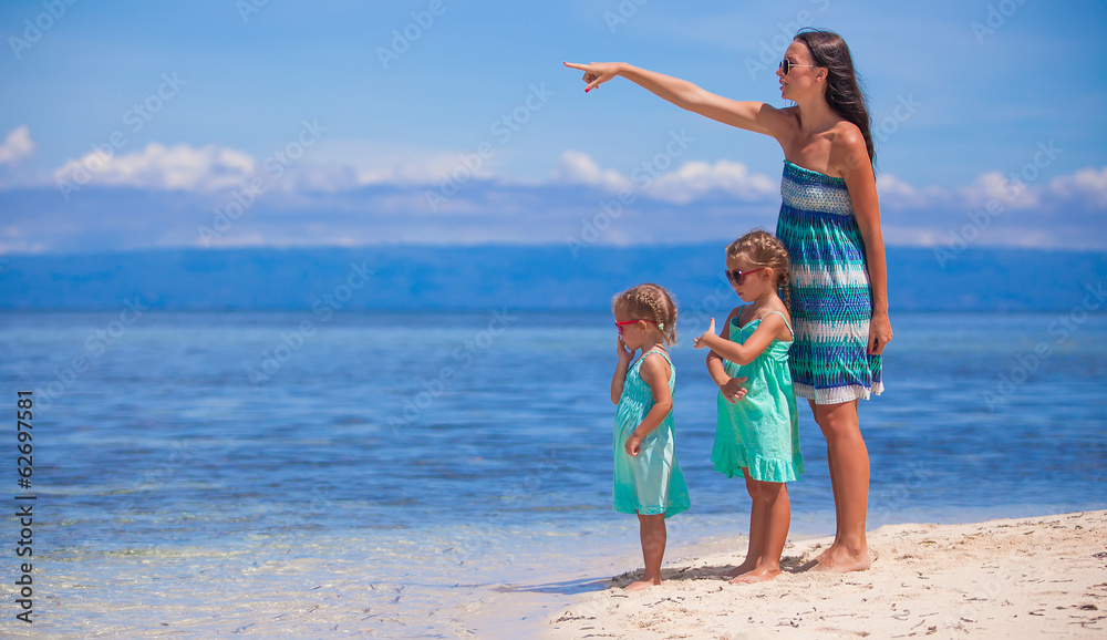 Young mother and two her daughters at exotic beach on sunny day