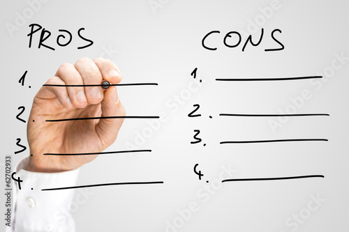 Man drawing up a list of pros and cons photo