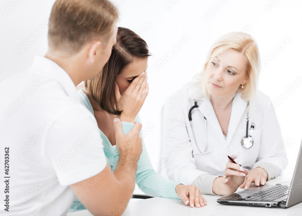 doctor with patients looking at laptop doctor with patients looking at laptop