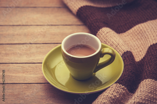 green cup of the coffee and vintage scarf.