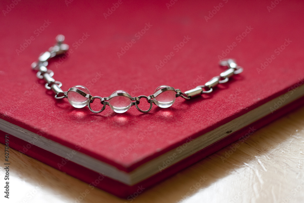Crystal bead bracelet on a red book Crystal bead bracelet on a red book