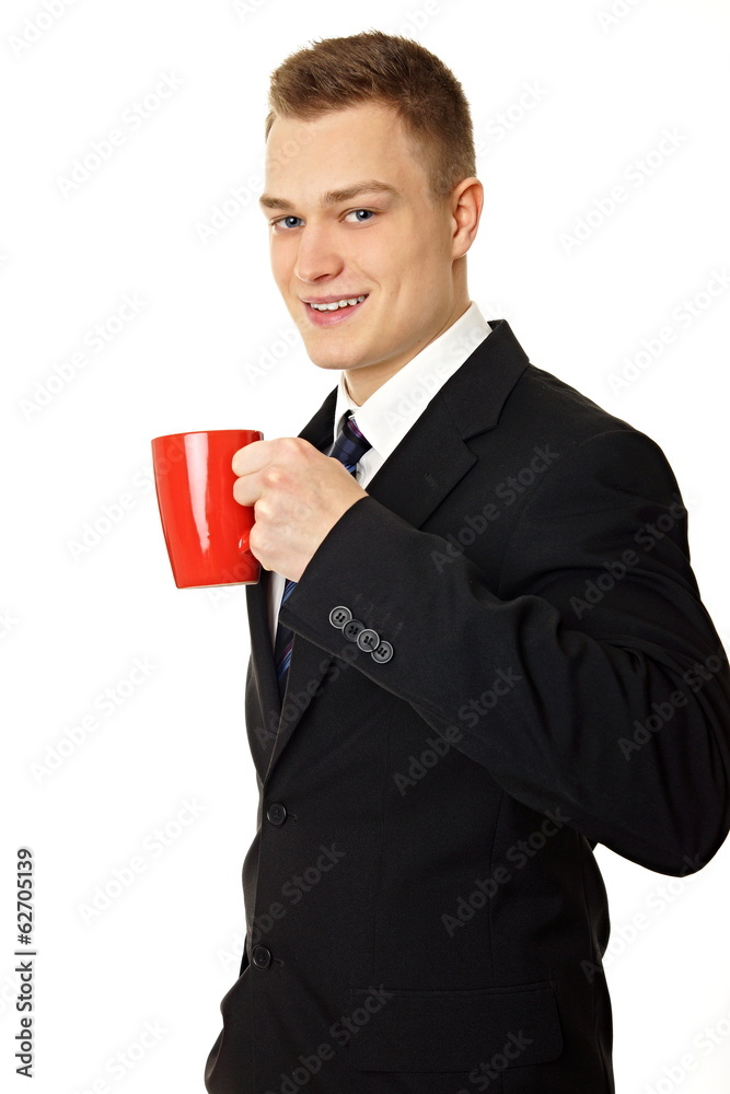 Young man at black suit drinks coffee Young man at black suit drinks coffee