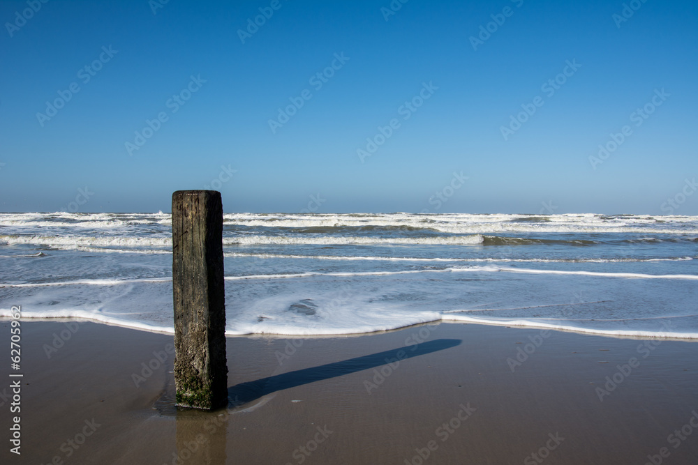 Wooden pole on Dutch beach