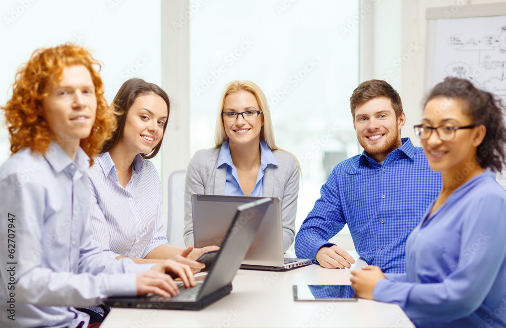 smiling team with laptop and table pc computers smiling team with laptop and table pc computers