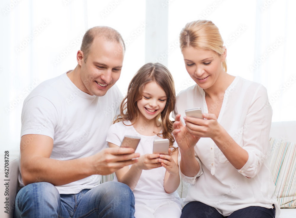 parents and little girl with smartphones at home parents and little girl with smartphones at home
