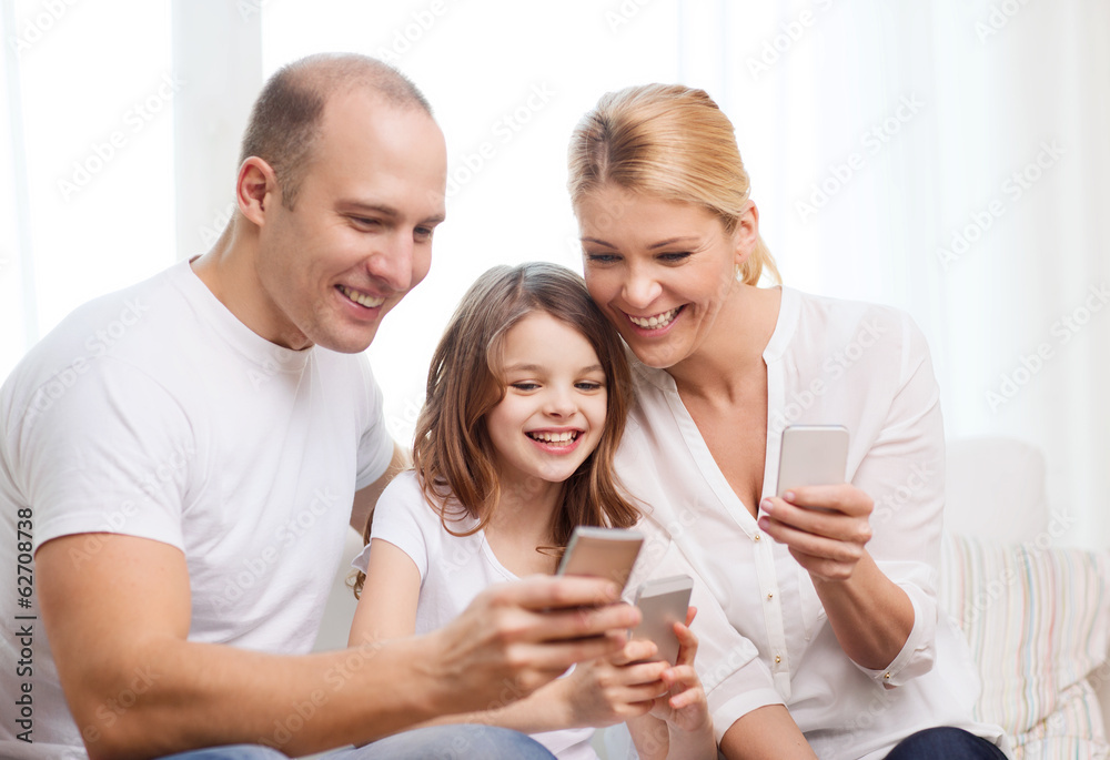 parents and little girl with smartphones at home parents and little girl with smartphones at home