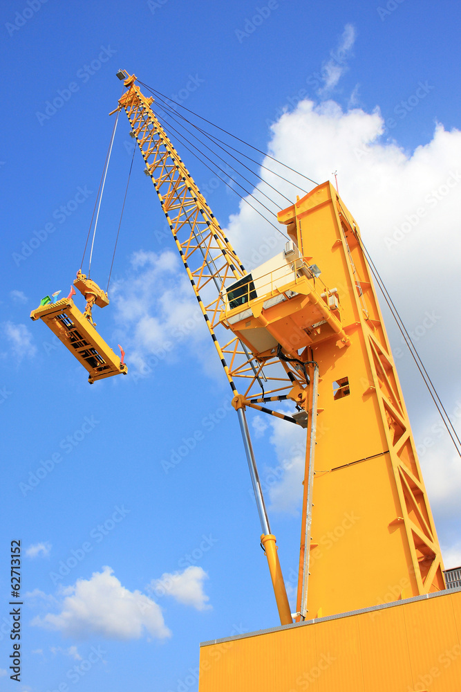 Yellow crane againts blue sky