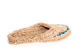 Old Russian sandals made of bark on the white background
