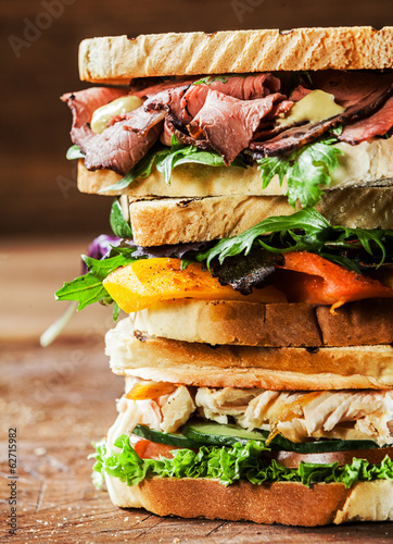 Stack of three delicious toasted sandwiches photo