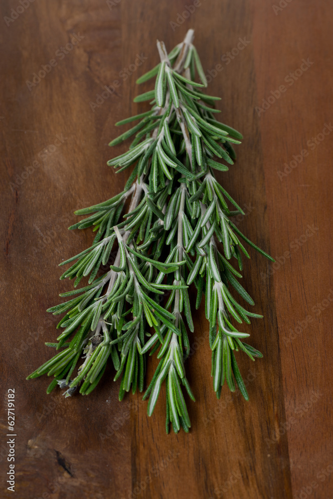 fresh rosemary on a wooden table fresh rosemary on a wooden table