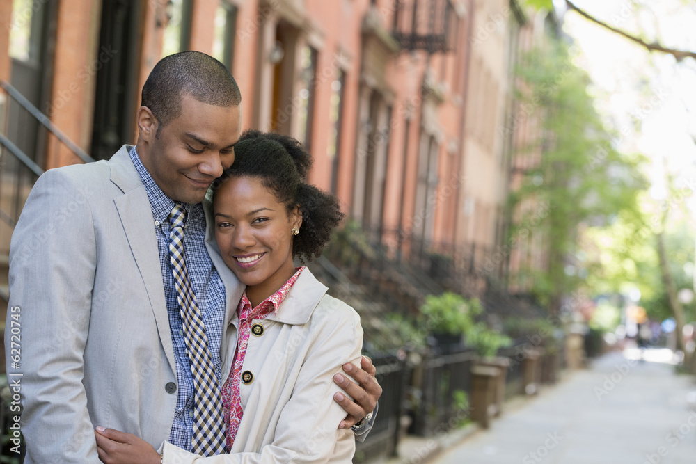 A Couple Standing Side By Side On A City Street. A Couple Standing Side By Side On A City Street.