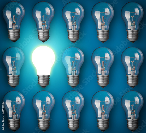 Idea concept with light bulbs on blue background