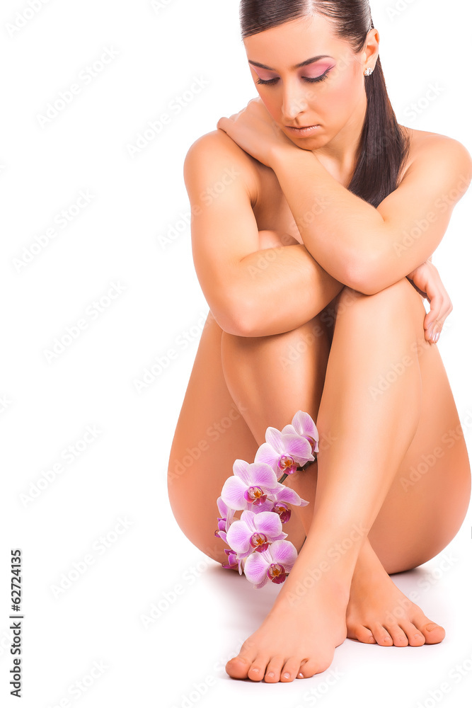 Obraz premium beautiful woman with orchid flower on white
