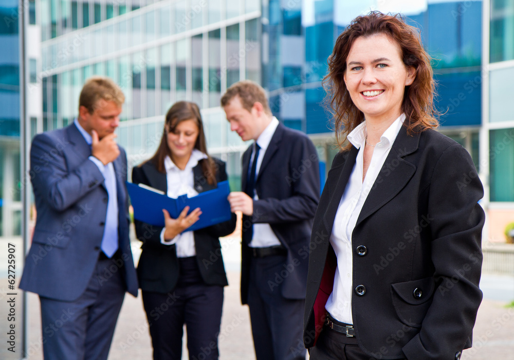 Group of business people with businesswoman leader on foreground Group of business people with businesswoman leader on foreground