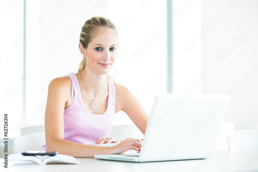 In the library - pretty. female student with tablet