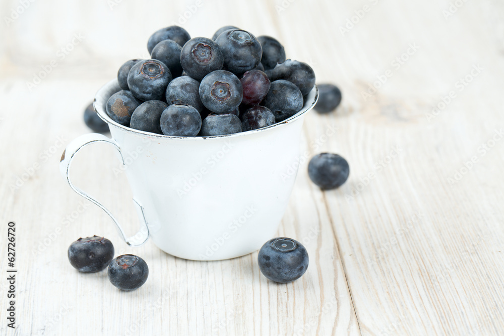 blueberries in a metallic cup on wooden table blueberries in a metallic cup on wooden table