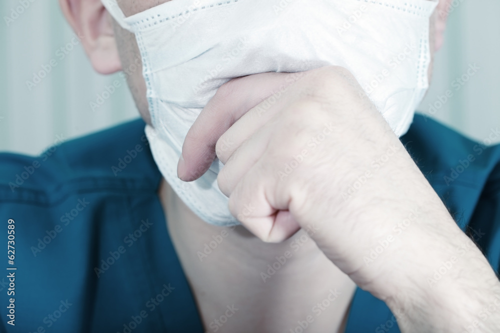 Man wearing a surgical mask thinking Man wearing a surgical mask thinking