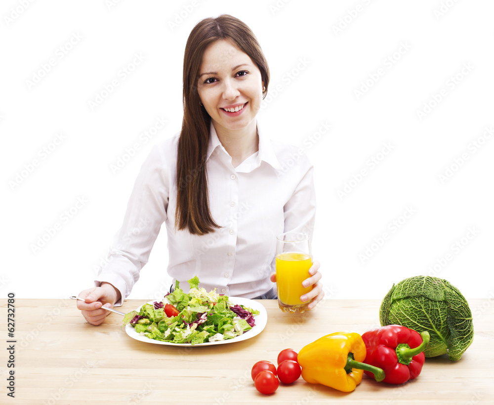 Happy young woman eating salad. Happy young woman eating salad.