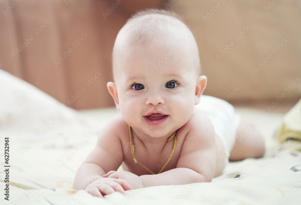Portrait of a cute 3 months baby lying down on a blanket Portrait of a cute 3 months baby lying down on a blanket