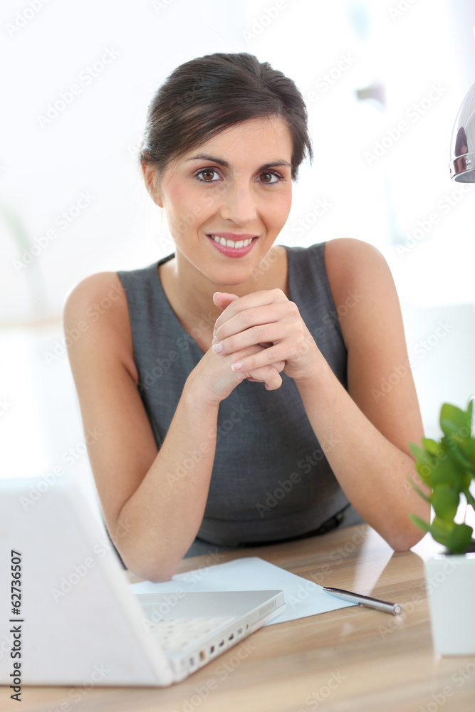 Beautiful businesswoman in office working on laptop Beautiful businesswoman in office working on laptop