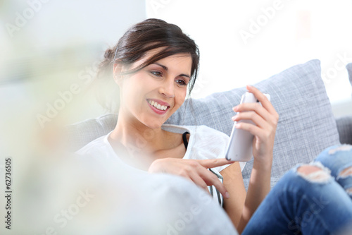 Young woman sending text message with smartphone