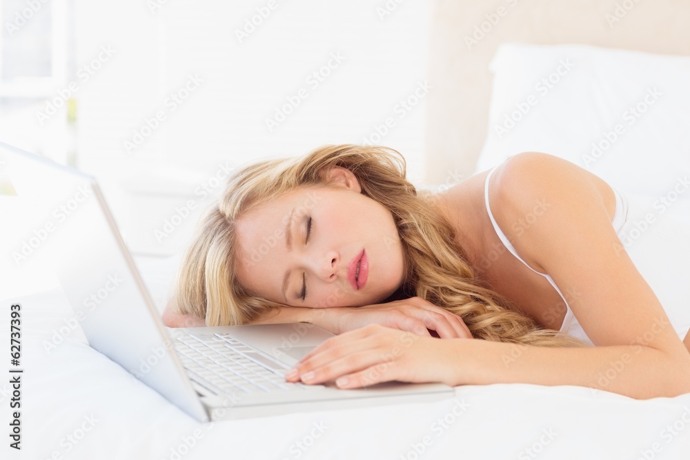 Cute young blonde sleeping beside her laptop Cute young blonde sleeping beside her laptop