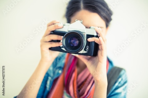 Attractive brunette holding camera up