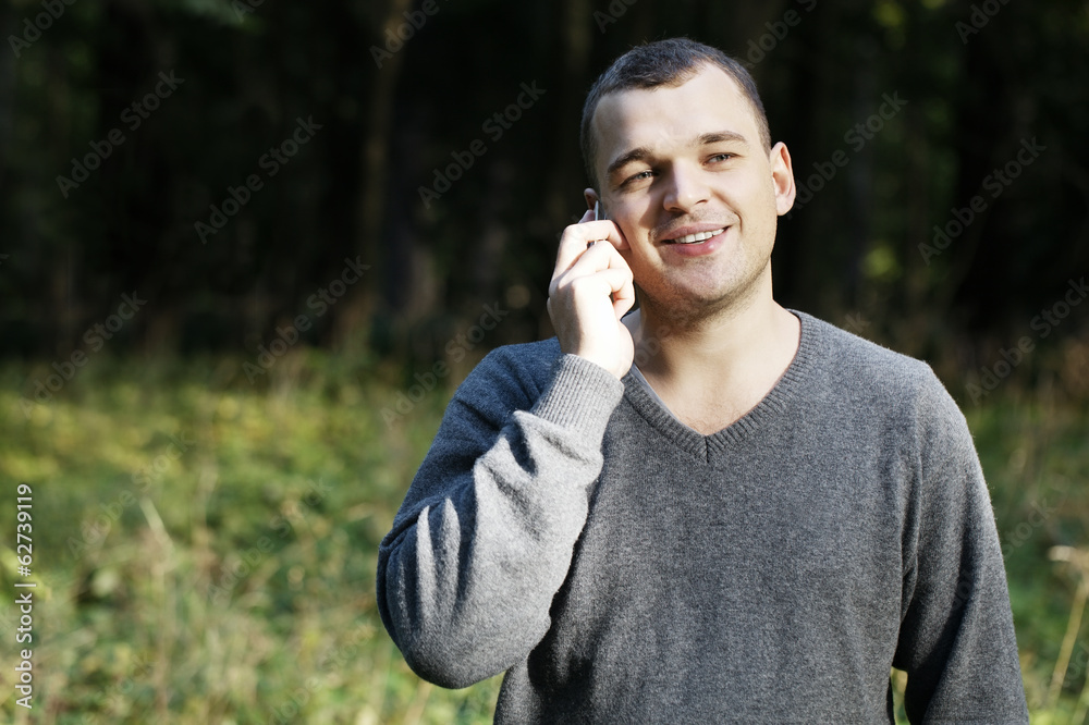 Man laughing as he chats on his mobile Man laughing as he chats on his mobile