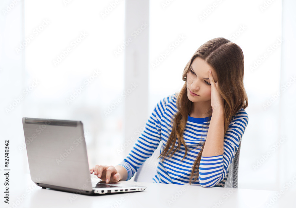 upset teenage gitl with laptop computer at home upset teenage gitl with laptop computer at home