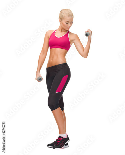 young sporty woman with light dumbbells