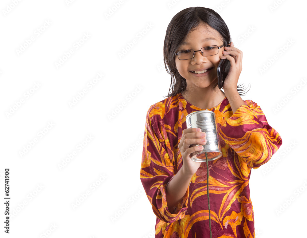 Young Asian girl with smartphone and tin can telephones Young Asian girl with smartphone and tin can telephones