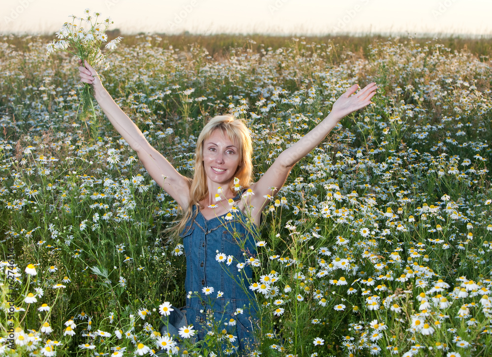 beautiful young woman in field with bouquet of camomiles beautiful young woman in field with bouquet of camomiles