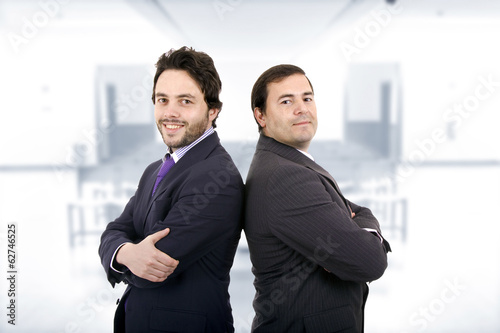 Two Businessman posing back to back together