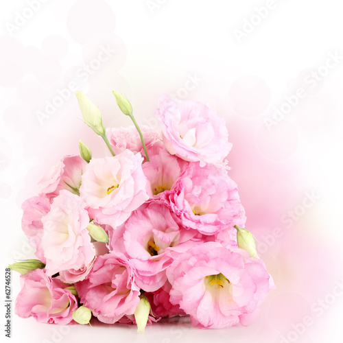 Bouquet of eustoma flowers on bright background © Africa Studio