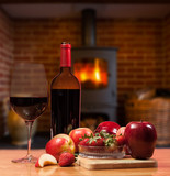 Red wine and fruit in front of burning fire