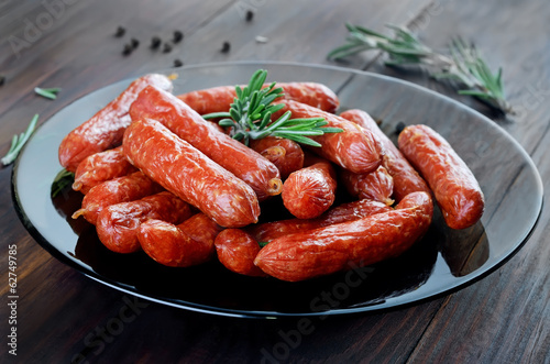 Smoked sausages on wooden table