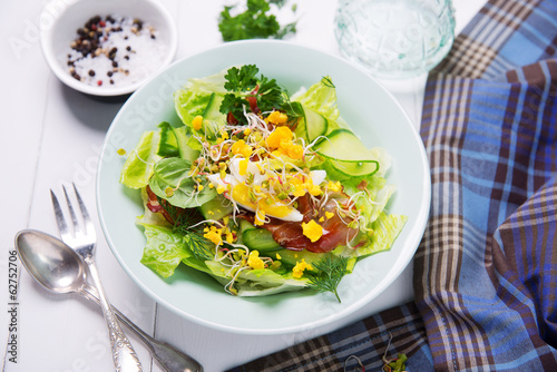 green salad with cucumber, crispy bacon and eggs