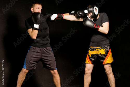 Two fit young boxers fighting in the ring