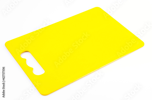 Yellow plastic cutting board on isolated white background