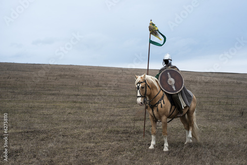 Anonymous ancient sarmatian horseman with spear in steppe
