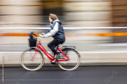 Cyclist in traffic on the city roadway