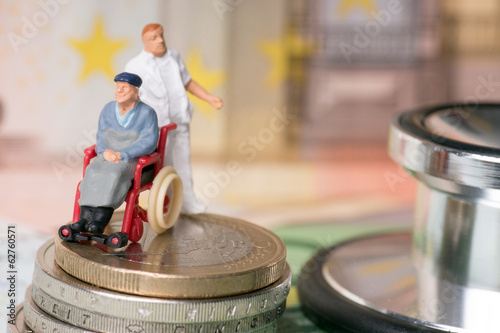 Rollstuhlfahrer mit Pflegepersonal und Geld
