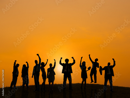 Silhouette of Business People Celebrating At Sunset